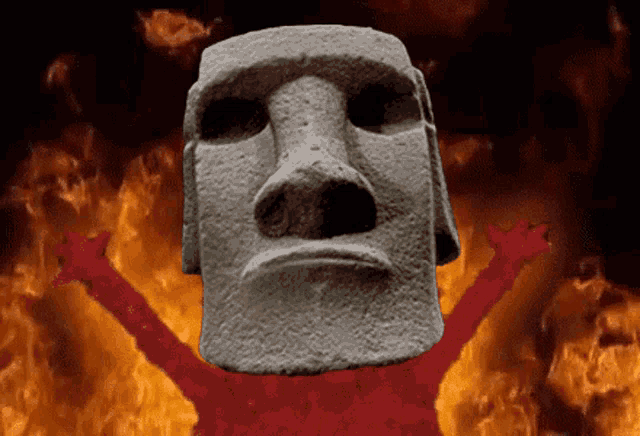 a statue of a man with his arms outstretched is surrounded by flames