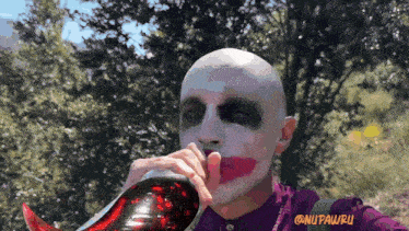 a man with a joker face painted on his face