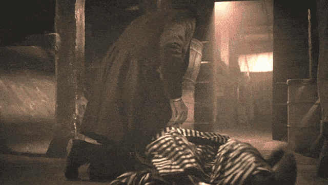 a woman in a striped shirt is laying on a bed