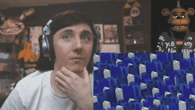 a man wearing headphones is looking at a screen with a monkey on it that says security