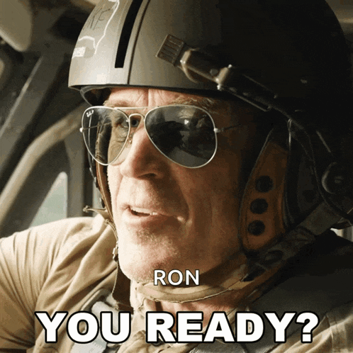 a man wearing a helmet and sunglasses is asking if he is ready