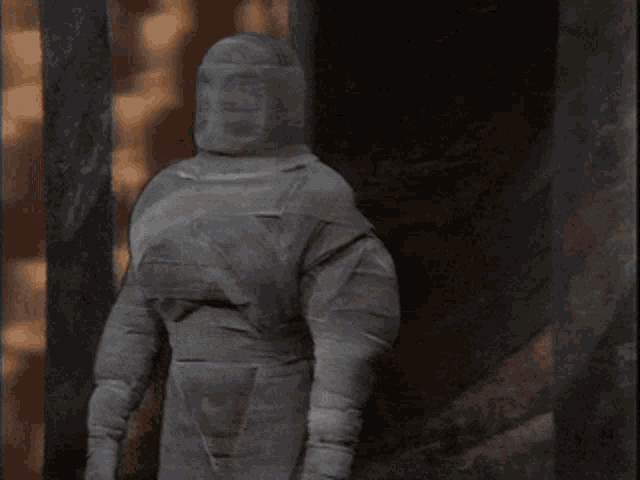a man in a mummy costume is standing in a doorway