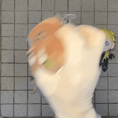a person is holding a stuffed animal in their hand