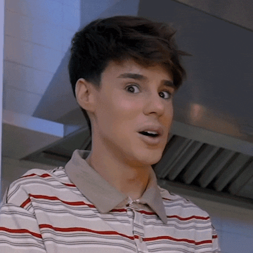 a young man with a surprised look on his face wears a striped shirt
