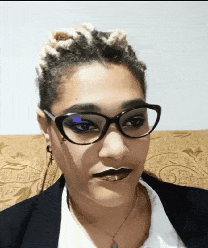 a woman wearing glasses and a white shirt has black lipstick on her lips