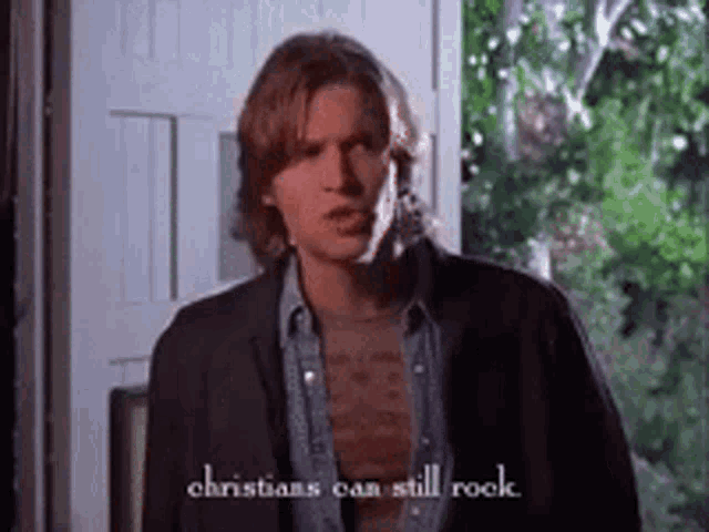 a man is standing in front of a door with the words christians can still rock written on the bottom