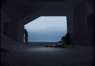 a woman is laying on the floor in front of a blue window