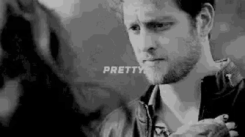 a man with a beard is looking at another man in a black and white photo with the words `` pretty '' .