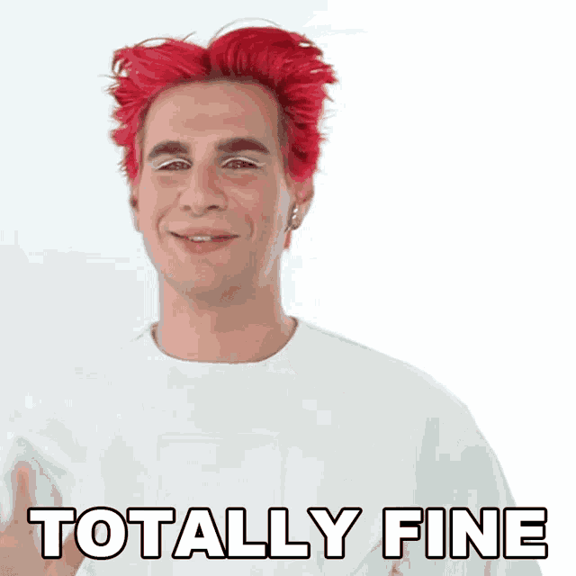 a man with red hair is wearing a white shirt and has the words totally fine on his face .
