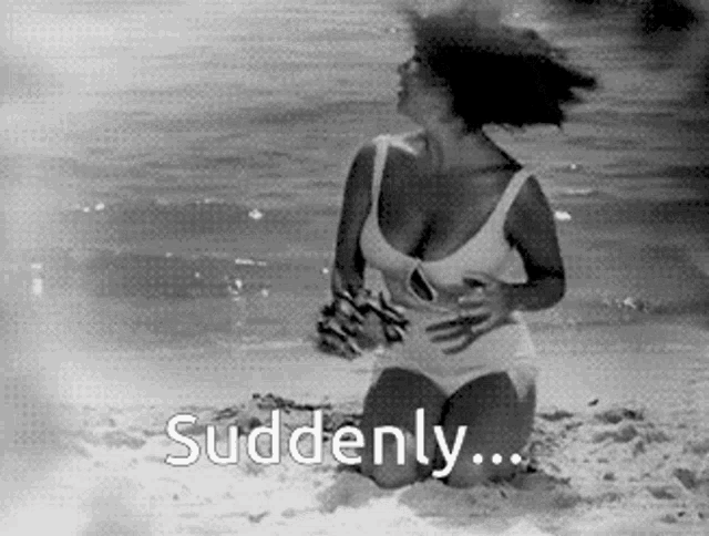 a woman is kneeling on the beach with the words `` suddenly '' written above her .