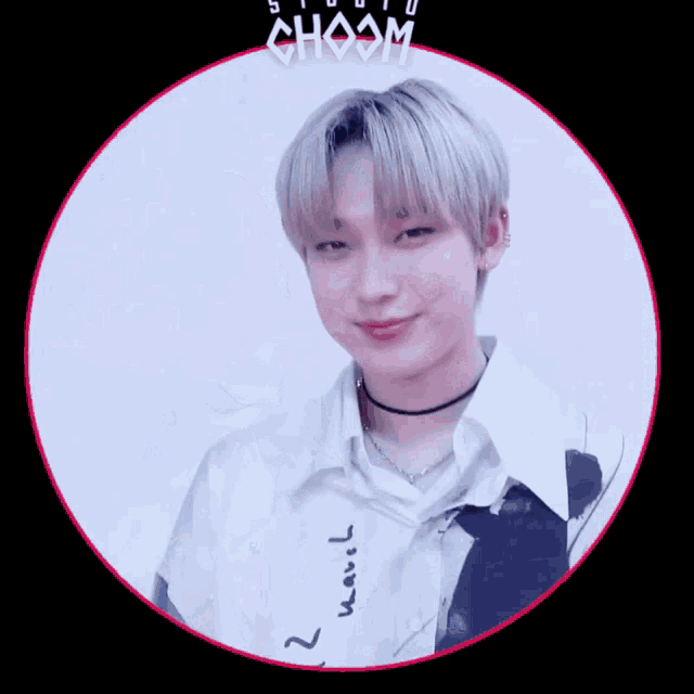 a young man wearing a choker and a white shirt is in a circle with the word choom above him