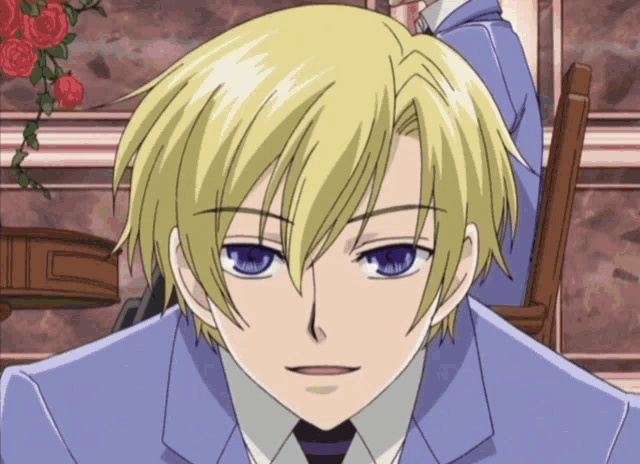 a man with blonde hair and blue eyes is wearing a suit