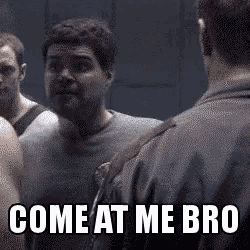 a man is standing in front of a mirror with the words `` come at me bro '' .