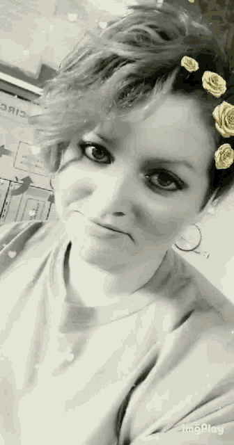 a black and white photo of a woman with a flower in her hair