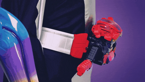 a person wearing a black suit and a red belt