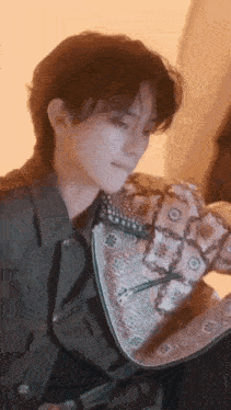a close up of a person wearing a jacket and a purse .