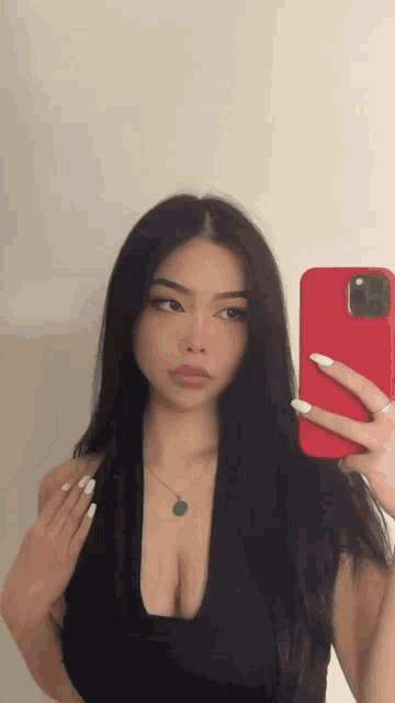 a woman is taking a picture of herself with her phone