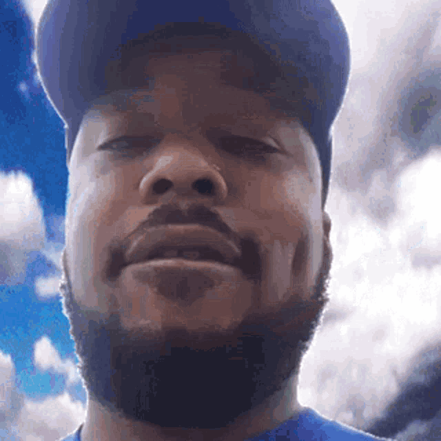 a man with a beard wearing a baseball cap