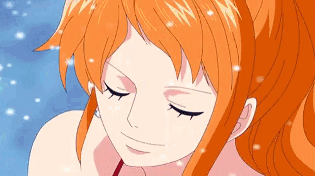 a close up of a woman 's face with her eyes closed and orange hair .
