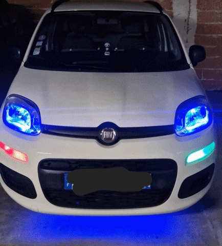 the front of a white fiat car with blue lights