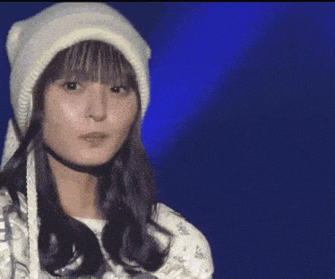 a woman wearing a white beanie and a white dress