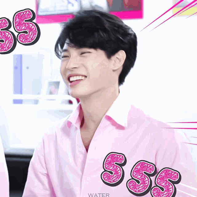 a young man wearing a pink shirt with the letters sss on the front