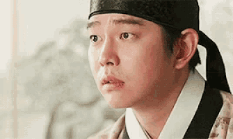 a close up of a man wearing a hat and a kimono
