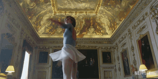 a woman dancing in a room with a netflix logo