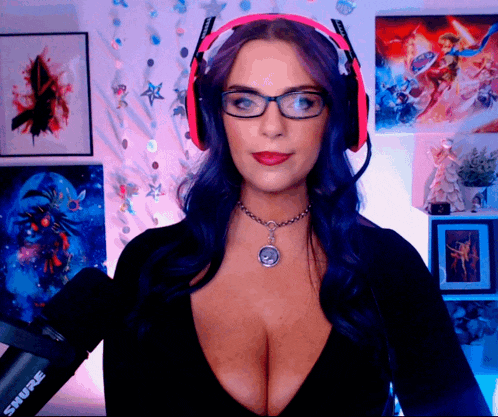 a woman wearing glasses and headphones is holding a shure microphone