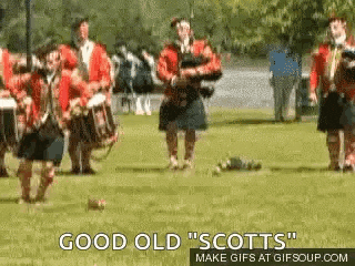 a group of men in kilts are playing bagpipes in a field with the words " good old scotts " above them
