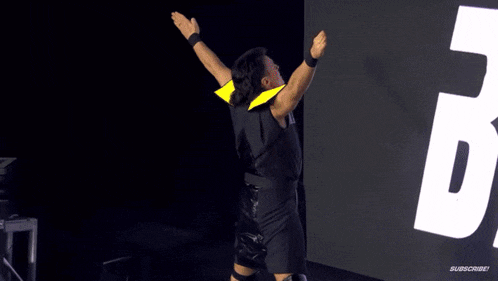 a man with his arms outstretched is standing in front of a large screen that says " hope "