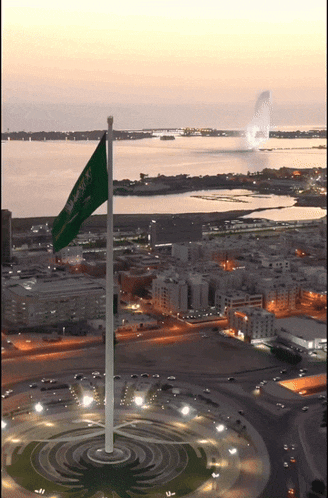 an aerial view of a city with a flag that says ' saudi arabia ' on it