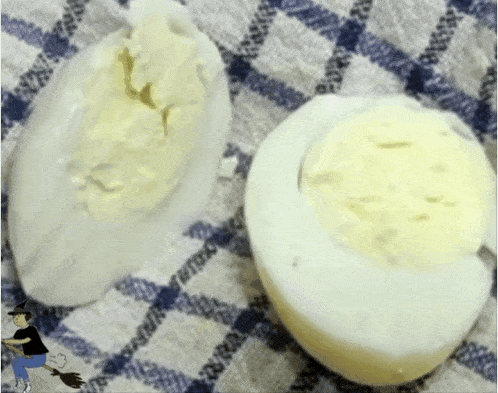 two hard boiled eggs are on a blue and white checkered cloth