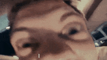 a close up of a person 's face with the letter i on the bottom right