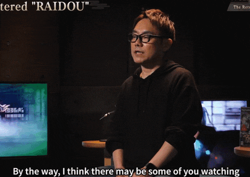 a man with glasses and a black hoodie says " raidou "