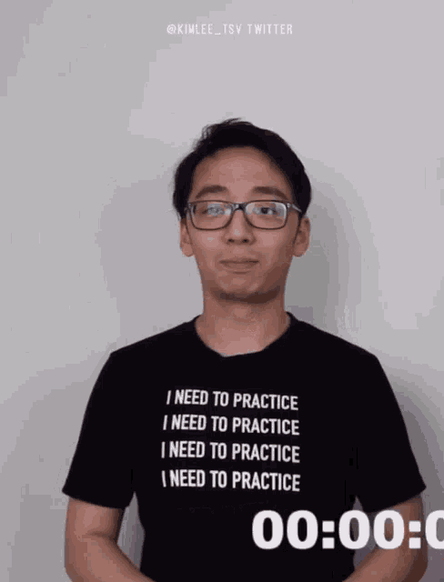 a man wearing glasses and a shirt that says i need to practice
