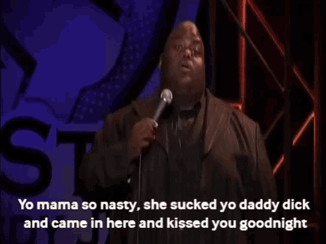 a man stands in front of a microphone and says yo mama so nasty she sucked yo daddy dick