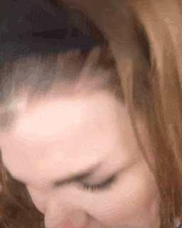 a close up of a woman 's head with her eyes closed .