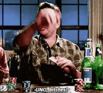 a man in a plaid shirt is playing a game of uno