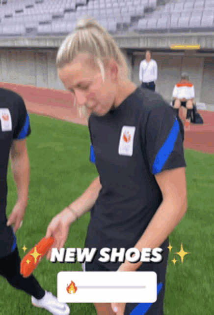 a woman is wearing a pair of new shoes on a field