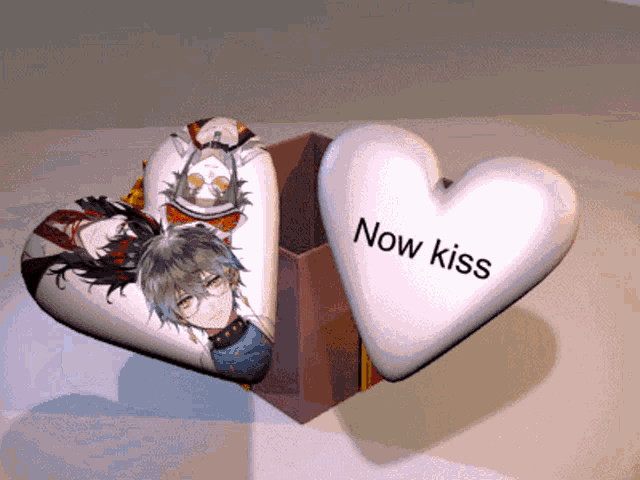 a heart shaped pillow that says now kiss