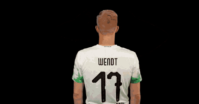 a man wearing a soccer jersey with the number 17 on the back