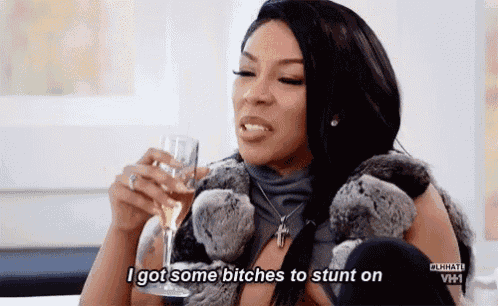 a woman is holding a glass of champagne and saying `` i got some bitches to stunt on `` .