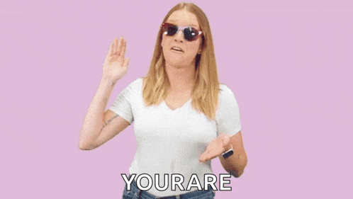 a woman wearing sunglasses is standing in front of a pink background that says very go yourare