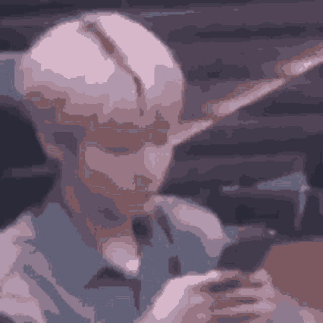 a pixelated image of a person looking at a phone