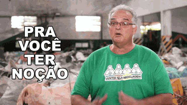 a man wearing a green t-shirt that says juntos pela reciclagem