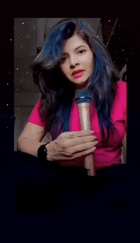 a girl with blue hair is holding a microphone in front of a sign that says ' e f da '