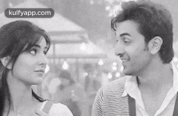 a man and a woman are looking at each other .