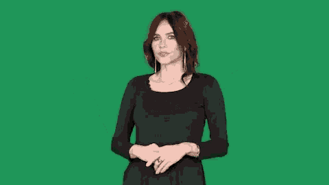 a woman in a black dress is making a surprised face