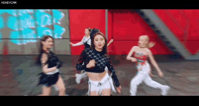a group of girls are dancing in front of a red wall with the words honeycam on the bottom